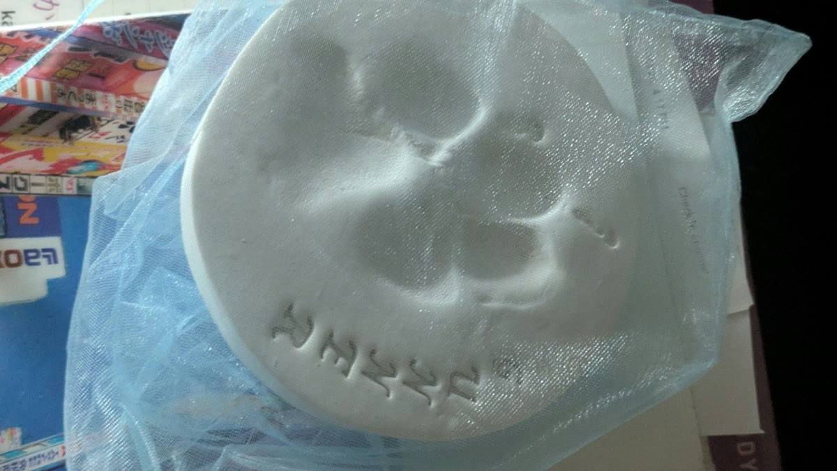 Gunner's pawprint, pressed in white clay and stamped with his name, kept in a mesh bag